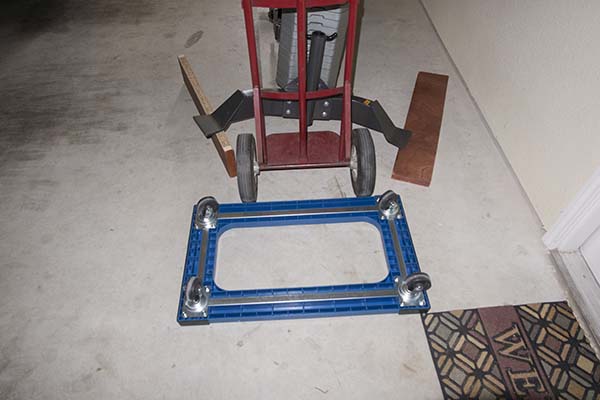 Photograph of Hoist V5 home gym, showing how to drop it from blocks that previously supported the frame during assembly.